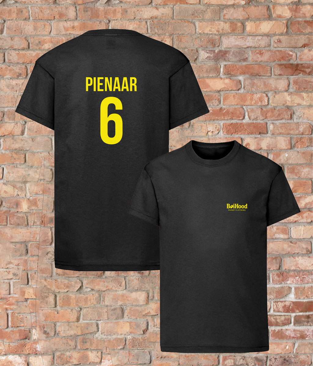 BoiHood Kids T-Shirt featuring 'PIENAAR 6' in yellow on the back, against a brick wall background.