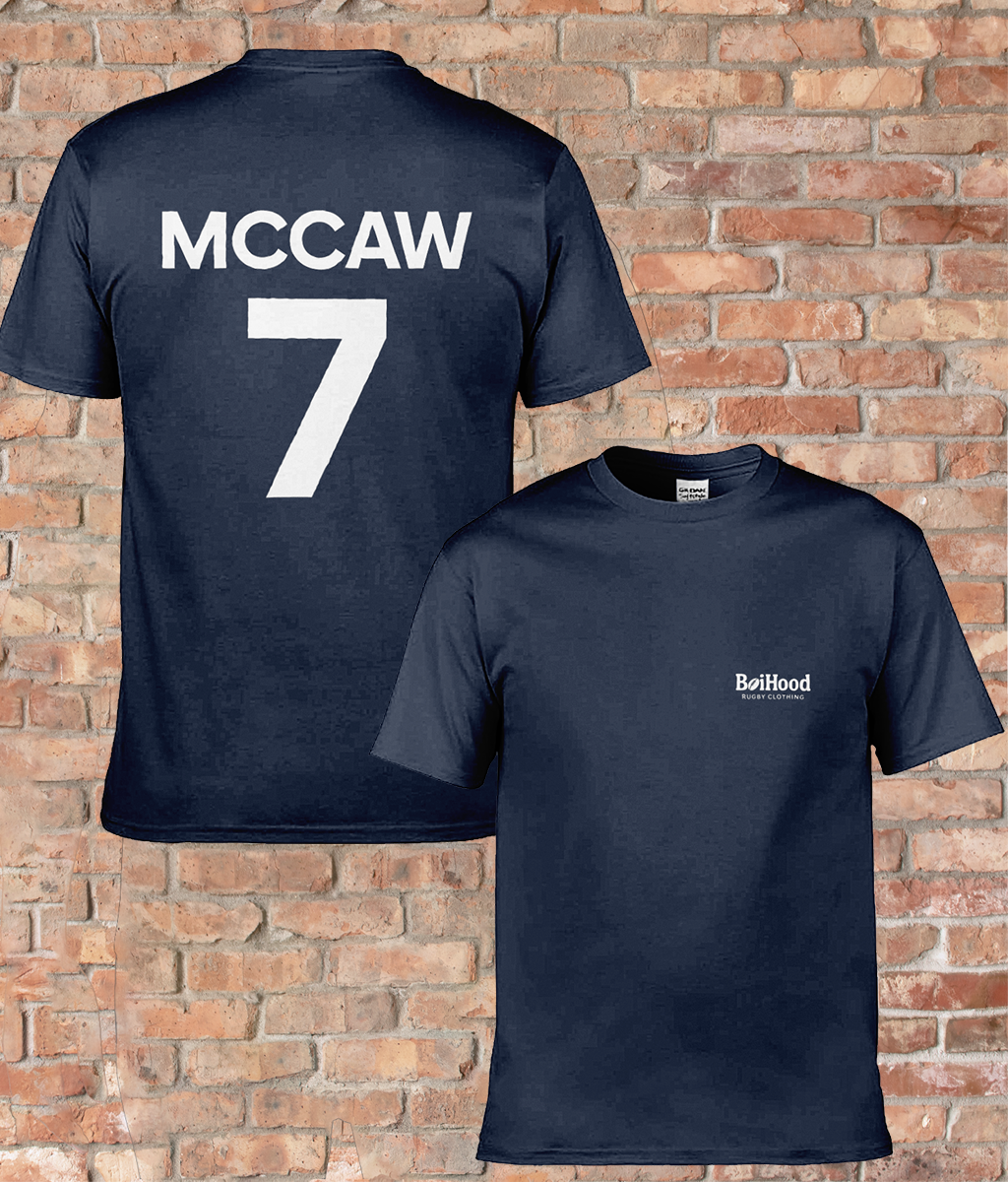 BoiHood Adult Unisex T-Shirt 'Rugby Legends' featuring 'MCCAW 7' on the back, stylish navy color against a brick background.